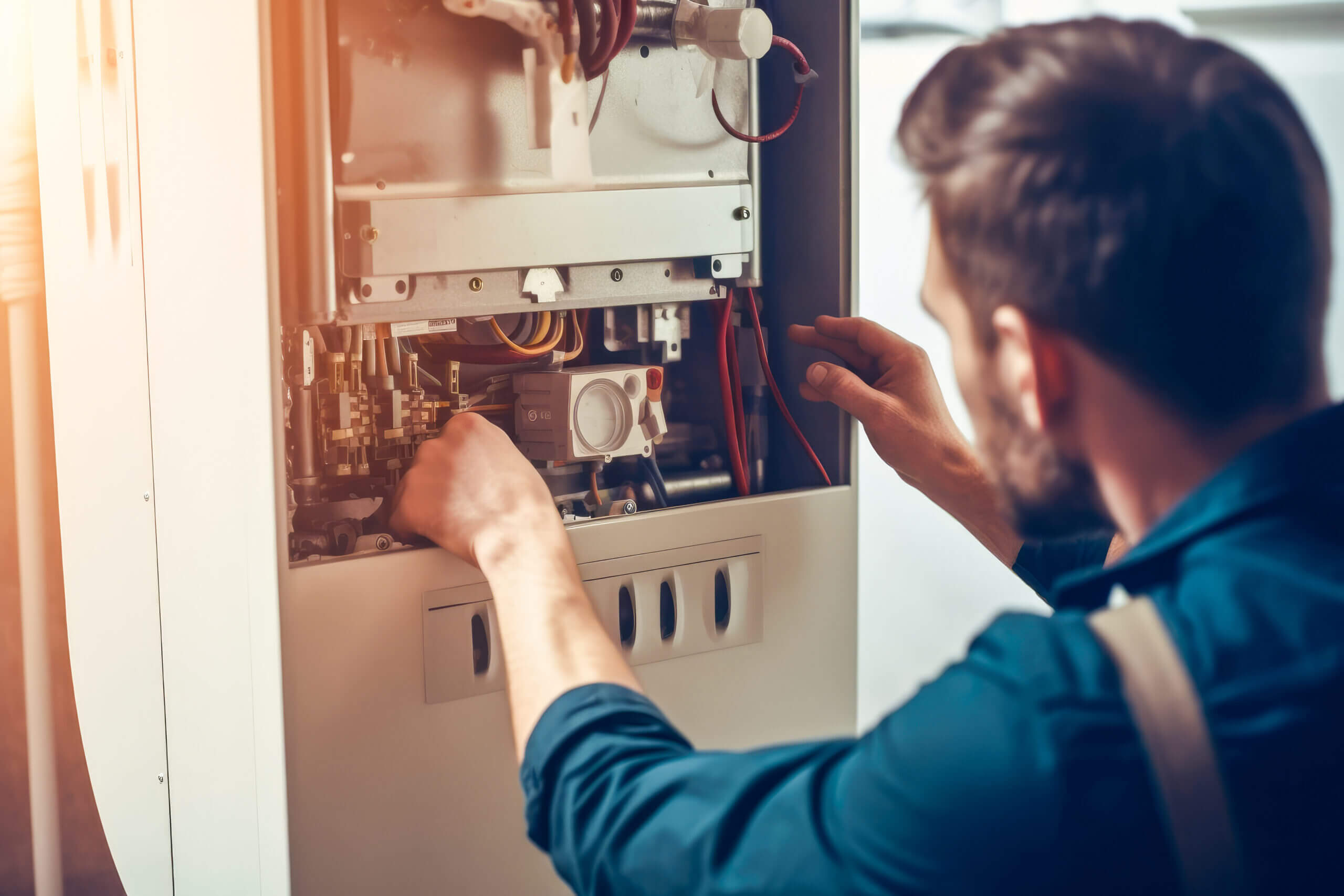 HVAC technician repairing a furnace to restore heating functionality.