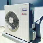 Outdoor heat pump AC condenser installed by ACS/American Comfort Services in San Diego